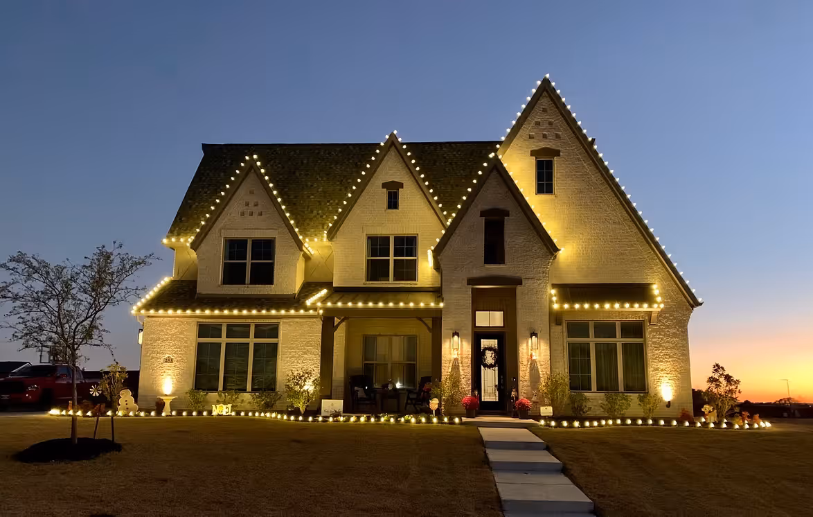 Custom-made Christmas lights tracing the roofline of a North Texas home